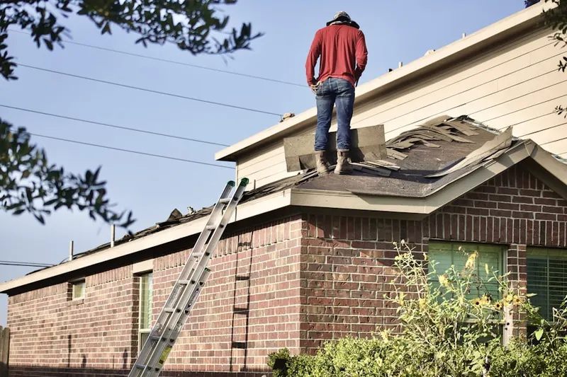 Professional roofer working on a residential roof in North Columbia